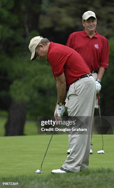 Jim Ryun is not in full agreement with Steve Buyer's line-up on the 3rd hole putting green during action in the First Tee Congressional Challenge...