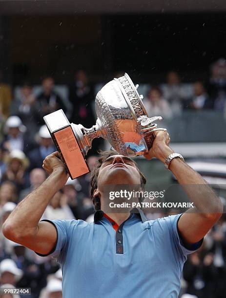 Swiss Roger Federer kisses the trophy after winning against Swedish player Robin Soderling during their French Open tennis men's final match on June...