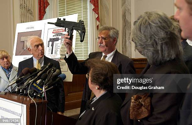 Bryan Miller, Director of Cease Fire New Jeresy, holds up a toy MAC 10 during a press conference to commemorate the one year anniversary of Beltway...