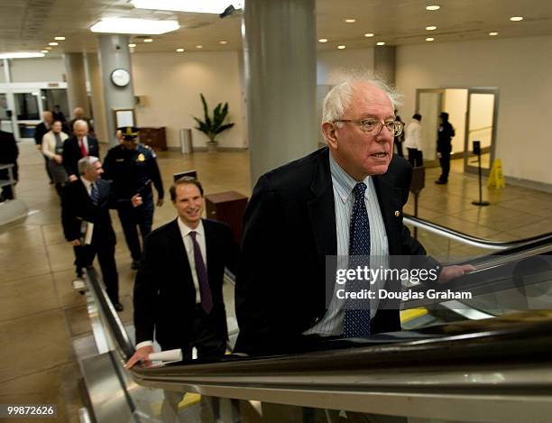 Bernard Sanders, I-VT., and Ron Widen, D-OR., heads to the luncheons in the U.S. Capitol through the Senate subway on December 22, 2009.