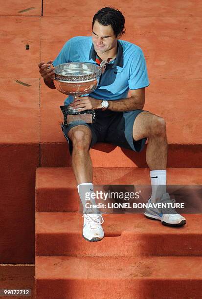 Swiss Roger Federer poses with the trophy after winning against Swedish player Robin Soderling during their French Open tennis men's final match on...