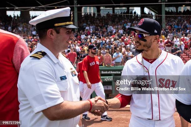 Mookie Betts of the Boston Red Sox greets a member of the Navy before a game against the Toronto Blue Jays on July 14, 2018 at Fenway Park in Boston,...