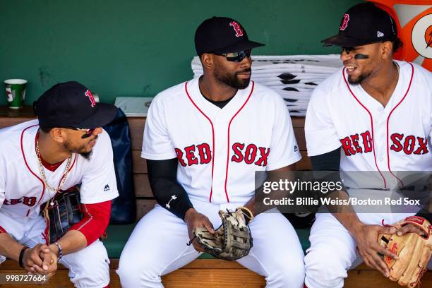 Mookie Betts, Jackie Bradley Jr. #19, and Xander Bogaerts of the Boston Red Sox talk in the dugout before a game against the Toronto Blue Jays on...