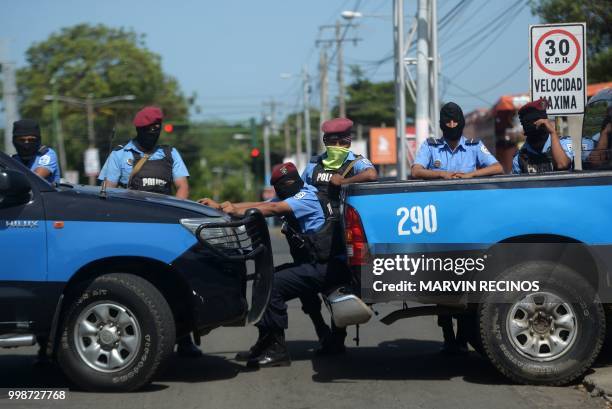 Police stand guard in the surroundings of the Cathedral as students of the National Autonomous University of Nicaragua -who hid overnight in a church...
