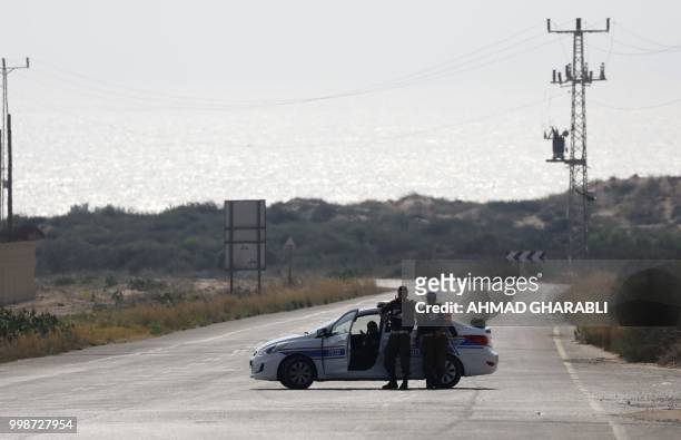 Police car blocks the road leading to Zikim beach near Ashkelon, after it was closed to visitors following an escallation in rocket fire from the...