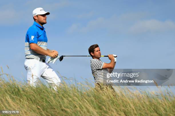 Robert Rock of England takes his tee shot on hole eleven as Tyrrell Hatton of England looks on during day three of the Aberdeen Standard Investments...