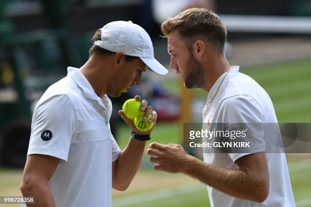 Player Mike Bryan and US player Jack Sock speak while playing South Africa's Raven Klaasen and New Zealand's Michael Venus during their mens' doubles...