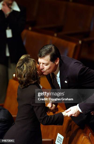 Katherine Harris, R-FL., gets a kiss from Tom Cole, R-OK., during the opening session of the 108th Congress.