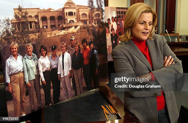 Ileana Ros-Lehtinen, R-Fla., looks at photos from her trip before the start of the news conference on the recently returned all-female congressional...