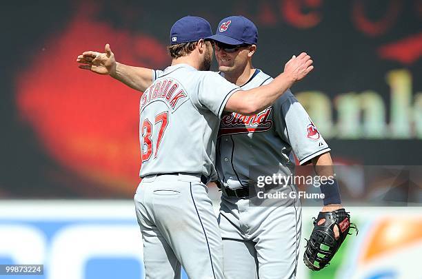 Jake Westbrook of the Cleveland Indians celebrates with Russell Branyan after a 5-1 victory over the Baltimore Orioles at Camden Yards on May 16,...