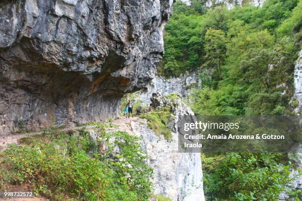 father and son in route of las xanas gorge. asturias, spain. - amaia - fotografias e filmes do acervo