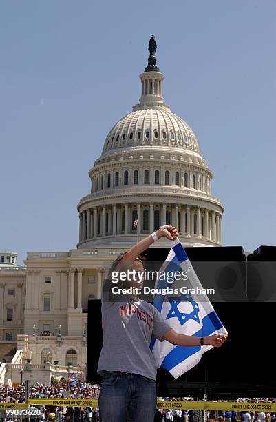 Noah Jubelirer of Wisconsin, waves an Israeli flag during the pro Israel protest on the West Front of the U.S. Capitol.