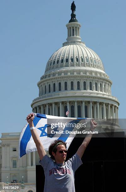 Noah Jubelirer of Wisconsin, waves an Israeli flag during the pro Israel protest on the West Front of the U.S. Capitol.