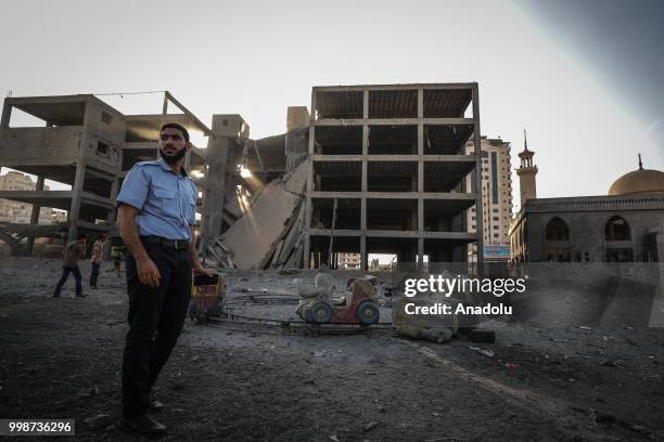 Palestinians inspect a destroyed building after Israeli fighter jets pounded Al Katiba region in Gaza City, Gaza on July 14, 2018.