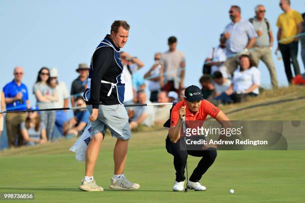 Haotong Li of China lines up a putt on hole seventeen during day three of the Aberdeen Standard Investments Scottish Open at Gullane Golf Course on...