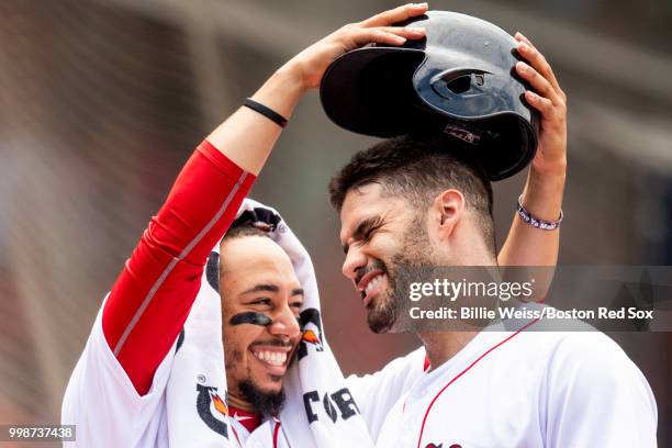 Martinez of the Boston Red Sox has his helmet removed by Mookie Betts after hitting a solo home run during the fourth inning of a game against the...