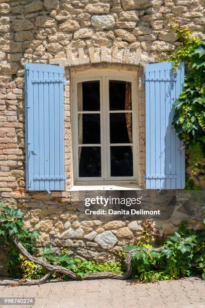 window with blue shutters, chateauneuf du pape, france - chateauneuf du pape stock pictures, royalty-free photos & images