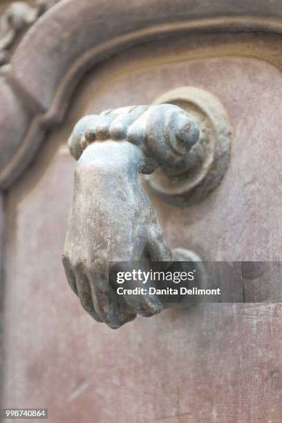 door knocker in shape of human hand, macon, burgundy, france - macon france stock-fotos und bilder