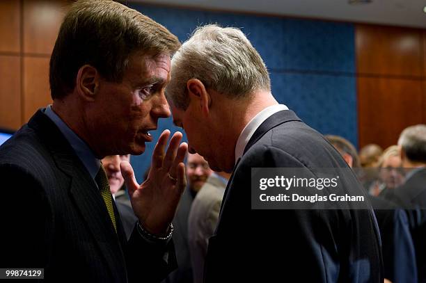 Mark Warner, D-VA., whispers to John Castellani, of the Business Roundtable after a press conference with the other freshman Democrats to introduce a...