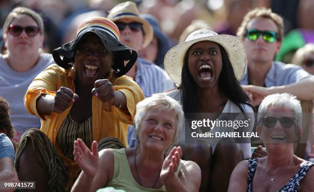 Spectators on Murray Mount react as Germany's Angelique Kerber plays against US player Serena Williams during their women's singles final match on...