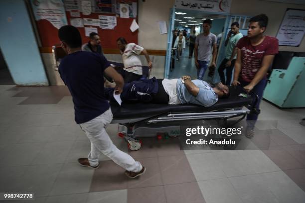 Injured Palestinians are being taken to al-Shifa hospital after Israeli fighter jets pounded Al Katiba region in Gaza City, Gaza on July 14, 2018.