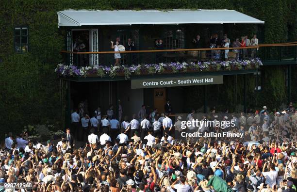 Angelique Kerber of Germany lifts the Venus Rosewater Dish on the balcony of Centre Court after defeating Serena Williams of The United States in the...