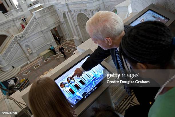 Librarian of Congress James H. Billington talks with school kids during a media preview of the new LOC Experience, which will feature interactive...