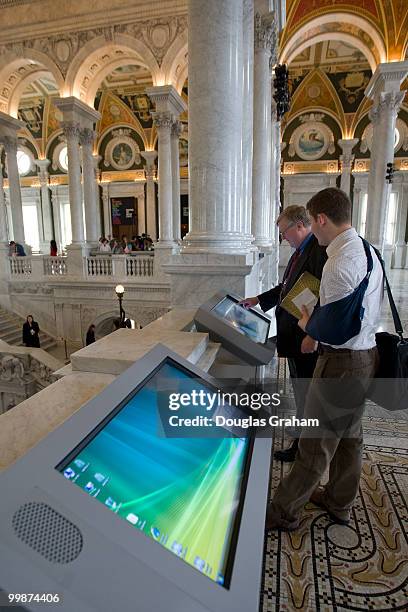 People look at some of the new touch screens placed through out the Jefferson Building during a media preview of the new LOC Experience, which will...