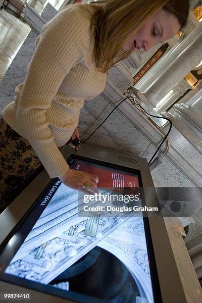 Erin Sanchez looks at some of the new touch screens placed through out the Jefferson Building during a media preview of the new LOC Experience, which...