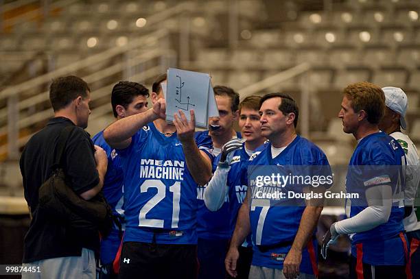 Members of Congress check over plays before each down during the Roll Call Longest Yard Football Classic charity football game being played at the...