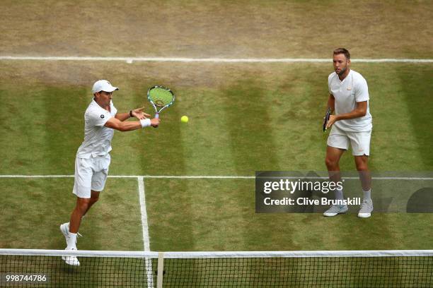 Mike Bryan and Jack Sock of The United States return against Raven Klaasen of South Africa and Michael Venus of New Zealand during the Men's Doubles...