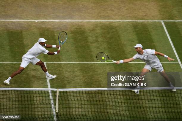 South Africa's Raven Klaasen and New Zealand's Michael Venus return against US player Mike Bryan and US player Jack Sock during their mens' doubles...