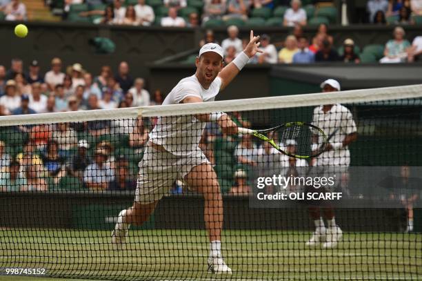 South Africa's Raven Klaasen and New Zealand's Michael Venus return against US player Mike Bryan and US player Jack Sock during their mens' doubles...