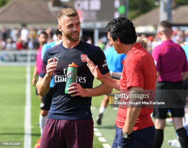Arsenal Head Coach Unai Emery talks to Calum Chambers during the pre-season friendly between Boreham Wood and Arsenal at Meadow Park on July 14, 2018...