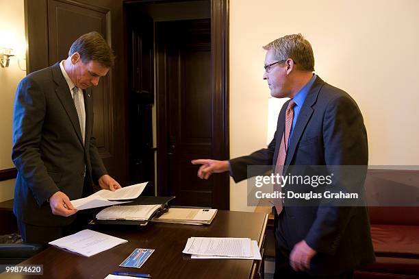 Mark R. Warner, D-VA and Communications Director Kevin Hall go over a statement to announced that the Federal Trade Commission has investigations...