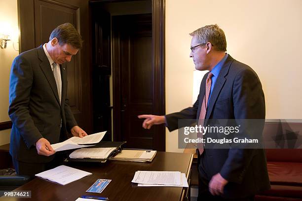 Mark R. Warner, D-VA and Communications Director Kevin Hall go over a statement to announced that the Federal Trade Commission has investigations...