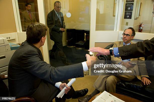 Mark R. Warner, D-VA waits with his Chief of Staff Luke Albee for Charles Schumer, D-NY in the Senate Radio and TV gallery to announced that the...