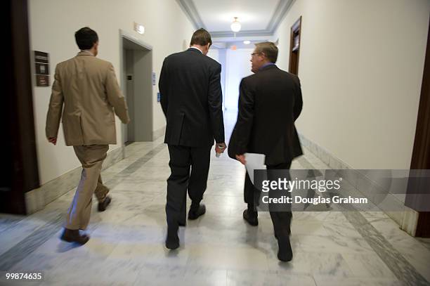 Chief of Staff Luke Albee, Senator Mark R. Warner, D-VA and Communications Director Kevin Hall walk to a press event in the Russell Senate Office...