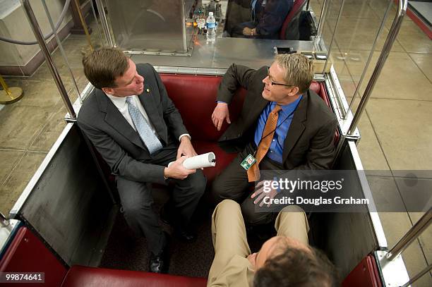 Senator Mark R. Warner, D-VA and Communications Director Kevin Hall talk in the Senate Subway on the way to a press event in the U.S. Capitol. May...