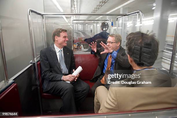 Senator Mark R. Warner, D-VA , Communications Director Kevin Hall and Chief of Staff Luke Albee talk in the Senate Subway on the way to a press event...