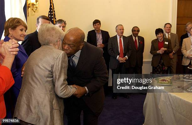 Mary McGrory and John Lewis, D-GA., share a hug during a reception honoring a former Washington Post political columnist.