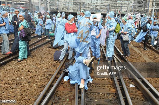 French anaesthetist nurses stand on tracks near the Montparnasse train station on May 18, 2010 in Paris, during a demonstration blocking the speed...