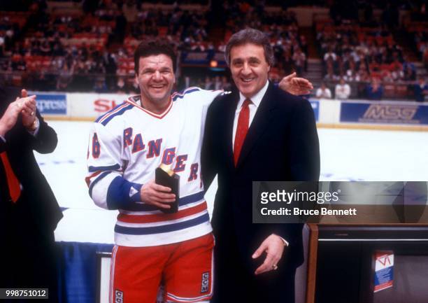 Phil Esposito poses with Marcel Dionne of the New York Rangers after Dionne passed Esposito with his 718th career goal during the game against the...