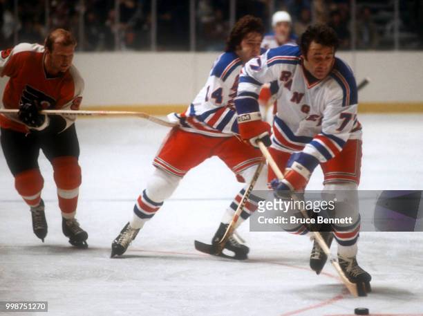 Phil Esposito of the New York Rangers skates on the ice with the puck during the 1979 Quarter Finals against the Philadelphia Flyers circa April,...