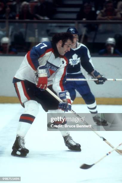 Phil Esposito of the New York Rangers skates on the ice with the puck during an NHL game against the Toronto Maple Leafs on January 25, 1978 at the...