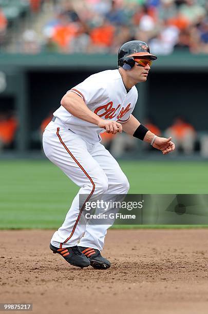 Luke Scott of the Baltimore Orioles takes a lead off of second base against the Cleveland Indians at Camden Yards on May 16, 2010 in Baltimore,...