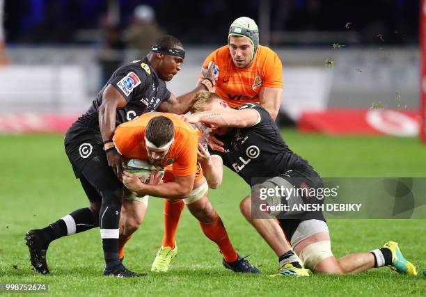 Sharks' hooker Chiliboy Ralepelle and eight man Daniel du Preez tackle Jaguares' flank Marcos Kremer as Guido Petti runs in to support during the...