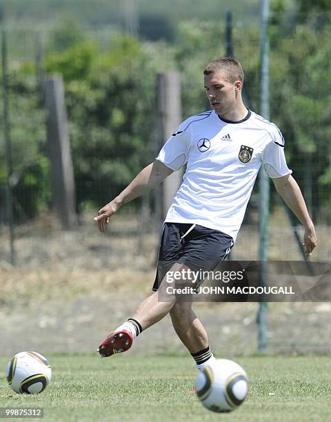 Germany's striker Lukas Podolski warms up with the ball during a training session at the Verdura Golf and Spa resort, near Sciacca May 16, 2010. The...