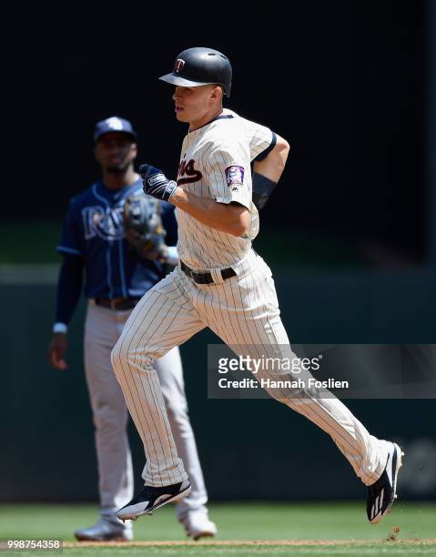 Adeiny Hechavarria of the Tampa Bay Rays looks on as Max Kepler of the Minnesota Twins rounds the bases after hitting a solo home run during the...