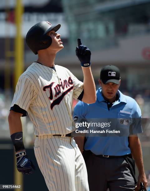 Max Kepler of the Minnesota Twins celebrates as he crosses home plate after hitting a solo home run against the Tampa Bay Rays as umpire James Hoye...